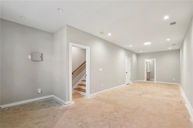 below grade area with stairs, baseboards, and recessed lighting