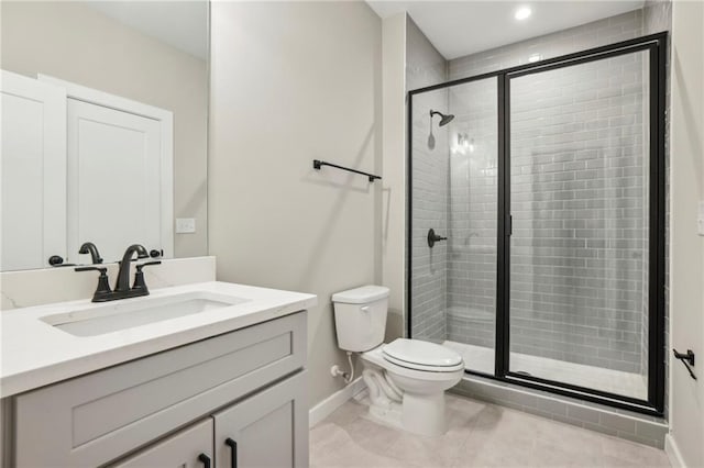 full bathroom with a shower stall, baseboards, toilet, tile patterned flooring, and vanity