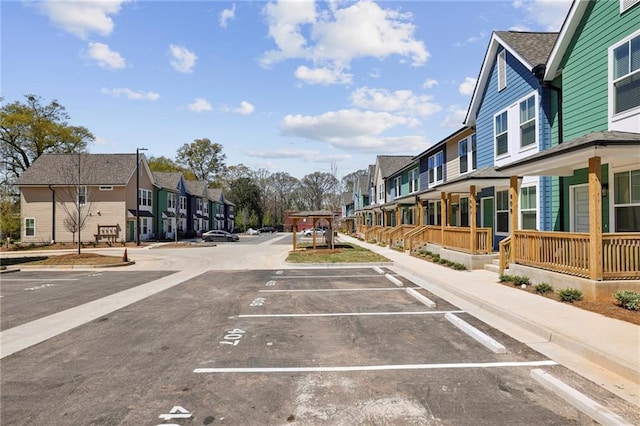 uncovered parking lot featuring a residential view