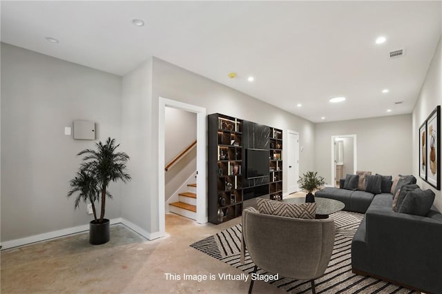 living area featuring concrete floors, stairs, recessed lighting, and baseboards