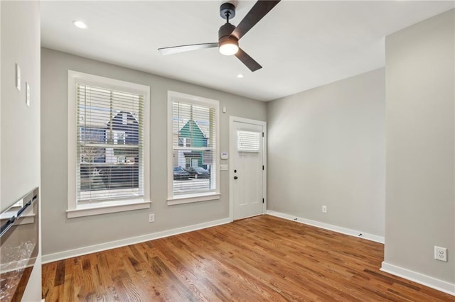 foyer with a ceiling fan, wood finished floors, baseboards, and recessed lighting