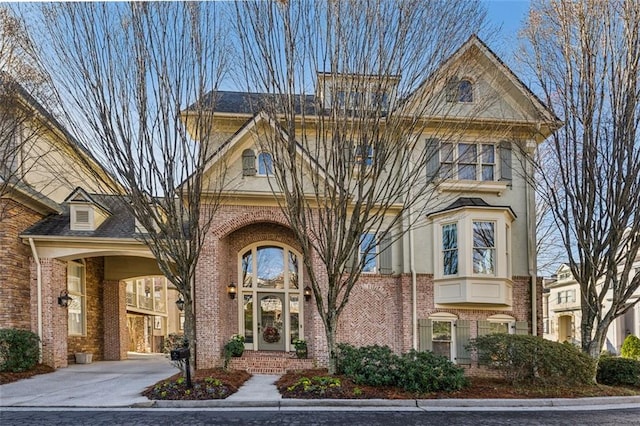 view of front of home featuring brick siding and driveway