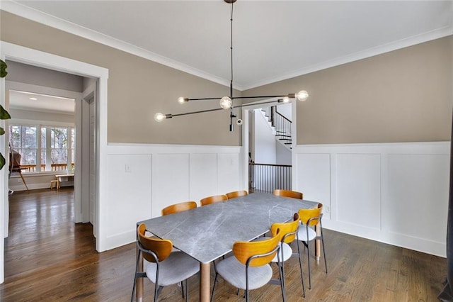 2304 Isla Run, Woodstock, GA 30188 - dining area with a decorative wall, a wainscoted wall, ornamental molding, stairway, and dark wood-type flooring