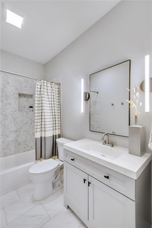 2304 Isla Run, Woodstock, GA 30188 - full bath with toilet, vanity, shower / bath combination with curtain, and marble look tiles