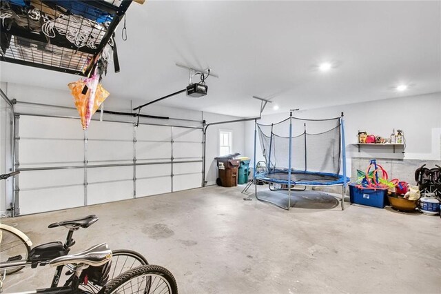 2304 Isla Run, Woodstock, GA 30188 - garage featuring a trampoline, a garage door opener, and recessed lighting