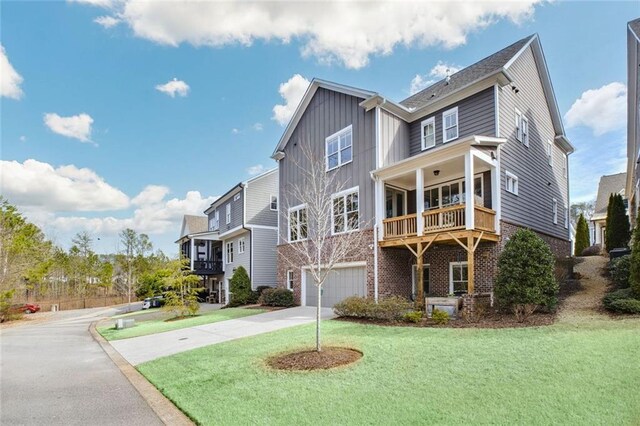 2304 Isla Run, Woodstock, GA 30188 - view of front of home featuring concrete driveway, a garage, brick siding, and board and batten siding