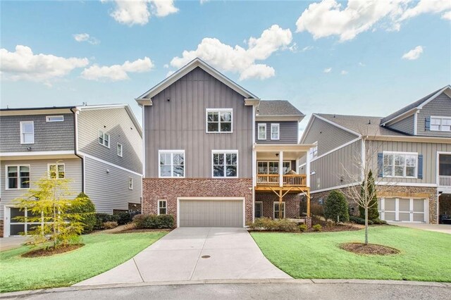 2304 Isla Run, Woodstock, GA 30188 - view of front of home with board and batten siding, a garage, driveway, and a front lawn