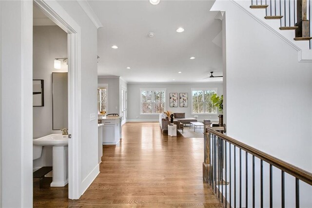 2304 Isla Run, Woodstock, GA 30188 - hall featuring light wood-style flooring, recessed lighting, baseboards, crown molding, and stairs
