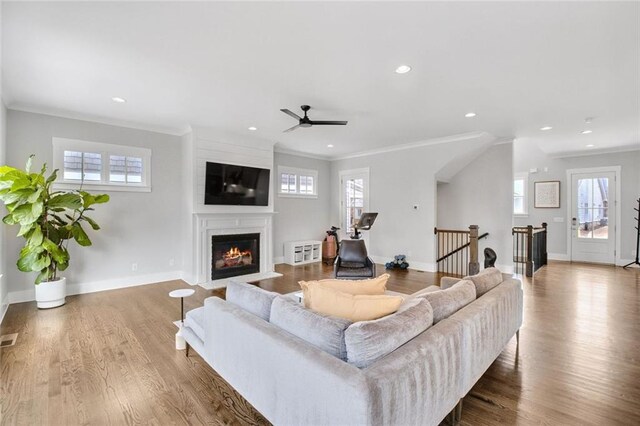 2304 Isla Run, Woodstock, GA 30188 - living area featuring a fireplace with flush hearth, wood finished floors, healthy amount of natural light, crown molding, and recessed lighting