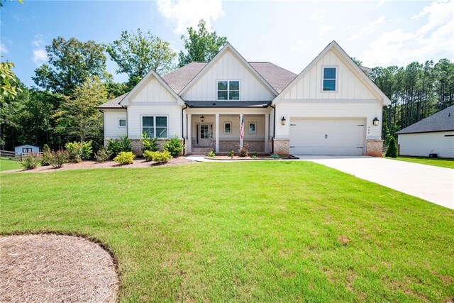 569 White Oak Way, Monroe, GA 30655 - modern farmhouse style home with a front lawn, covered porch, and a garage