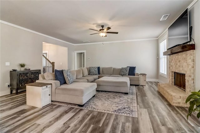 569 White Oak Way, Monroe, GA 30655 - living room featuring ceiling fan, a fireplace, wood-type flooring, and crown molding