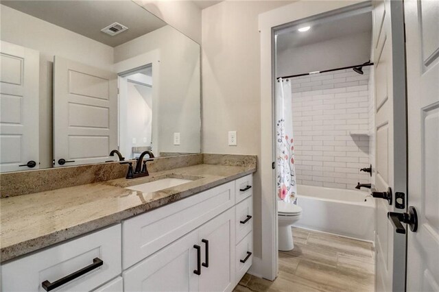 569 White Oak Way, Monroe, GA 30655 - full bathroom featuring vanity, hardwood / wood-style flooring, toilet, and shower / bath combo with shower curtain