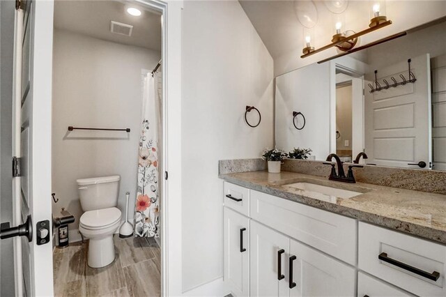 569 White Oak Way, Monroe, GA 30655 - bathroom with a shower with shower curtain, vanity, and toilet