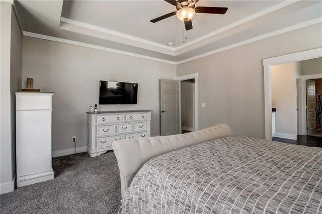 569 White Oak Way, Monroe, GA 30655 - bedroom with dark colored carpet, ceiling fan, and a raised ceiling