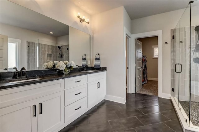 569 White Oak Way, Monroe, GA 30655 - bathroom with tile patterned floors, a shower with door, vanity, and a healthy amount of sunlight
