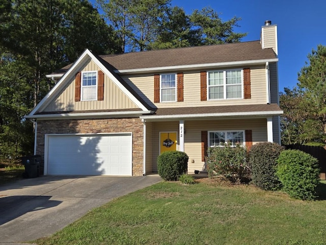 view of front of home with a garage and a front lawn