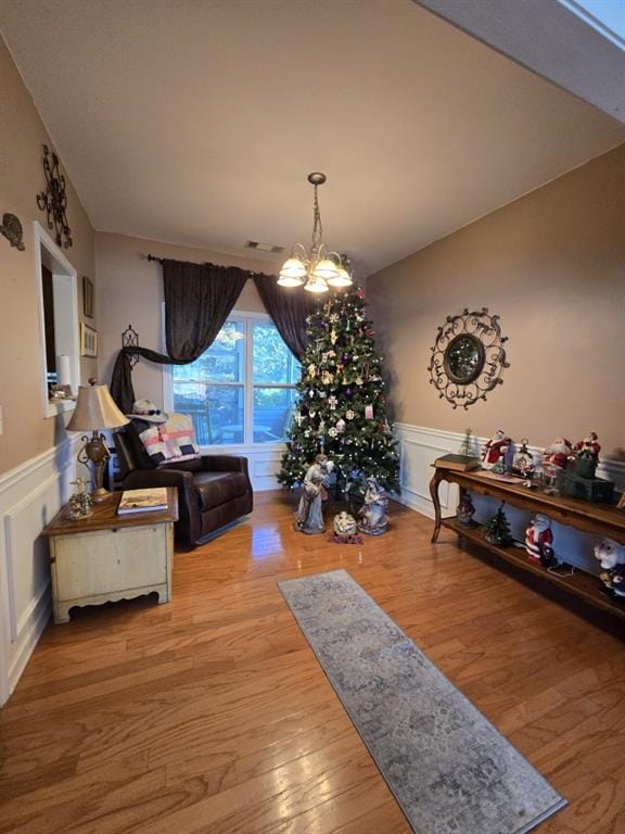 interior space featuring an inviting chandelier and light hardwood / wood-style floors