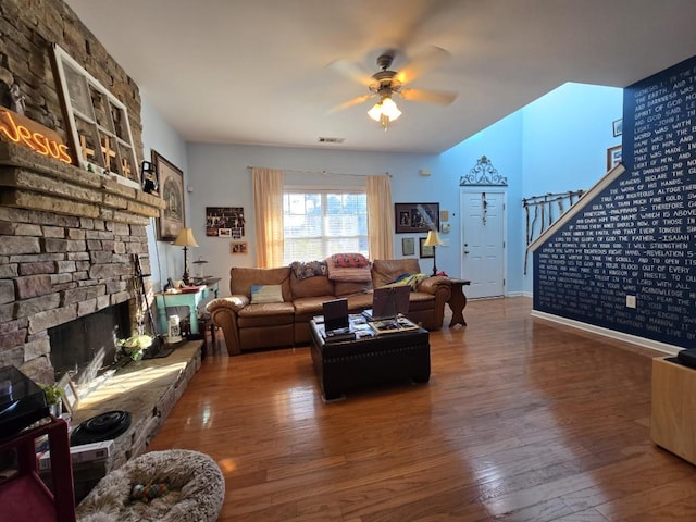 living room featuring hardwood / wood-style floors, a fireplace, and ceiling fan