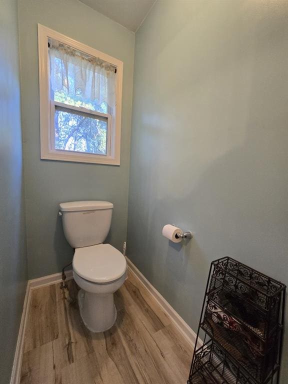 bathroom featuring hardwood / wood-style flooring and toilet