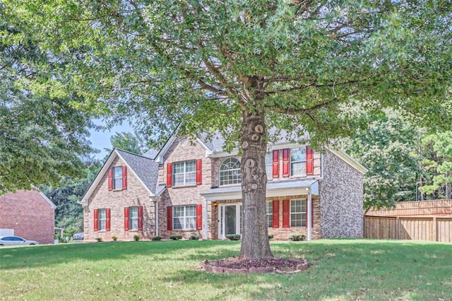 colonial inspired home featuring a front yard