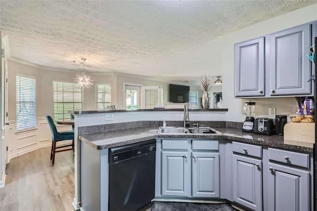 kitchen featuring sink, hanging light fixtures, dark hardwood / wood-style floors, black dishwasher, and kitchen peninsula