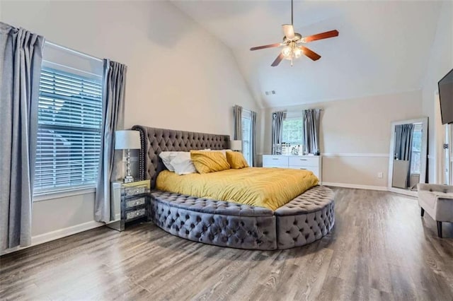 bedroom with ceiling fan, high vaulted ceiling, and hardwood / wood-style floors