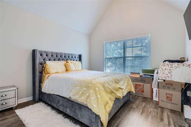 bedroom with dark hardwood / wood-style floors and high vaulted ceiling