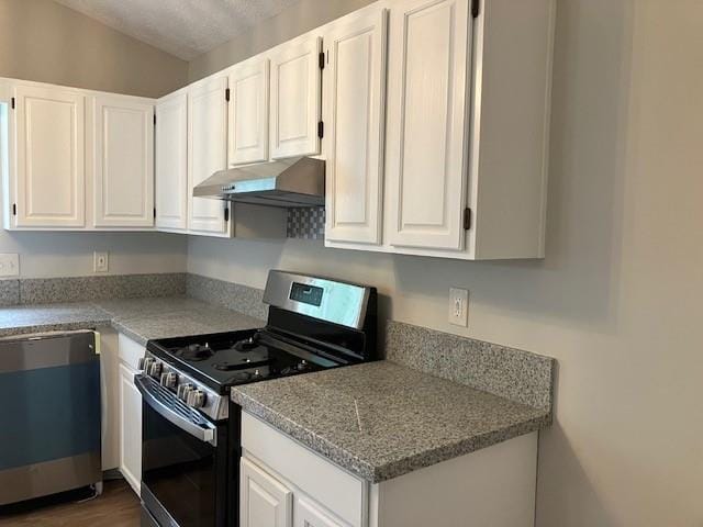 kitchen featuring white cabinets, light stone counters, appliances with stainless steel finishes, and dark wood-type flooring