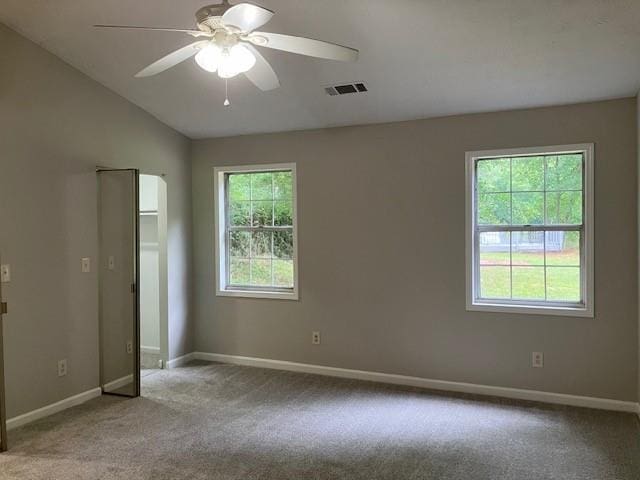 carpeted empty room featuring ceiling fan and lofted ceiling