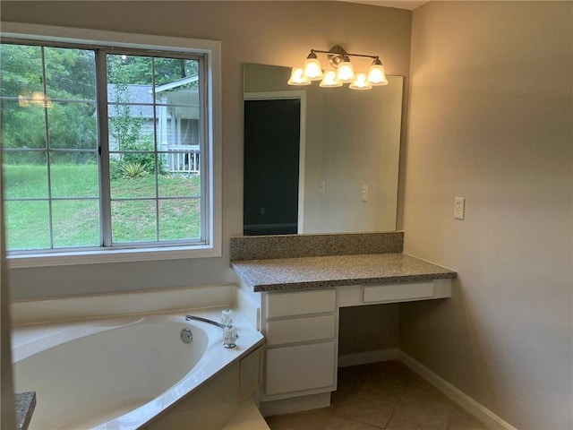 bathroom featuring a washtub, tile patterned flooring, and vanity