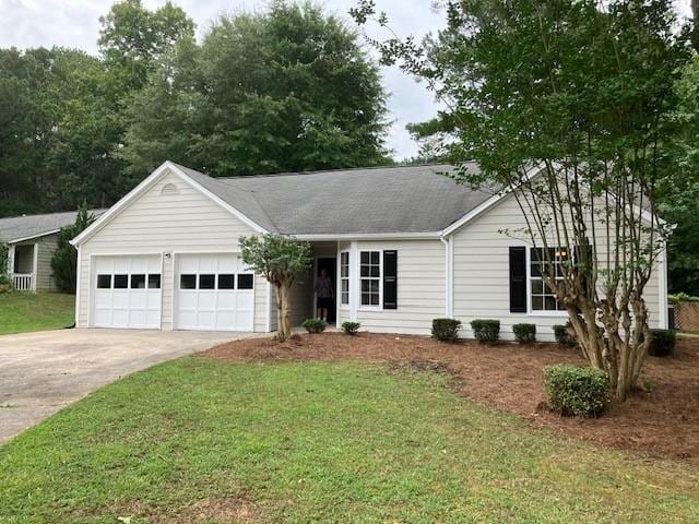 single story home with a garage and a front yard