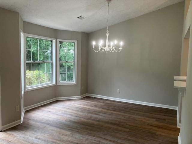 unfurnished dining area with dark hardwood / wood-style floors and a notable chandelier