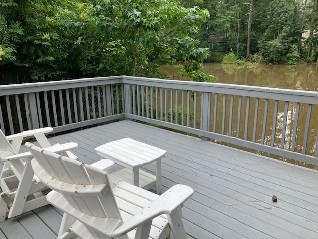 wooden deck featuring a water view