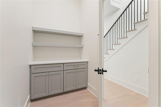 260 Guild Ln, Fayetteville, GA 30214 - bar featuring baseboards, light wood-style flooring, and stairway