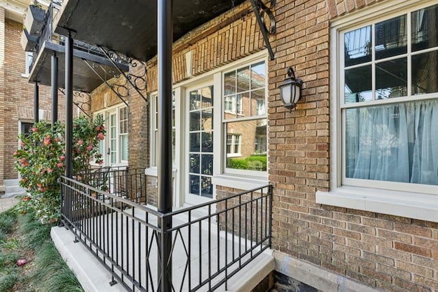 exterior space with brick siding and a porch