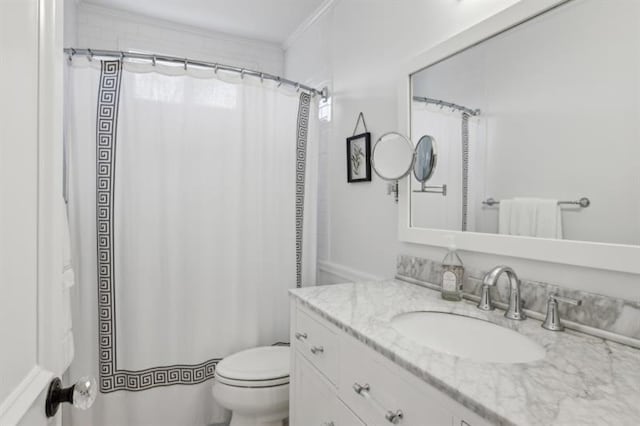 full bath with vanity, ornamental molding, and toilet