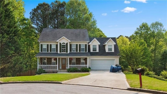 colonial house featuring a garage, covered porch, and a front lawn