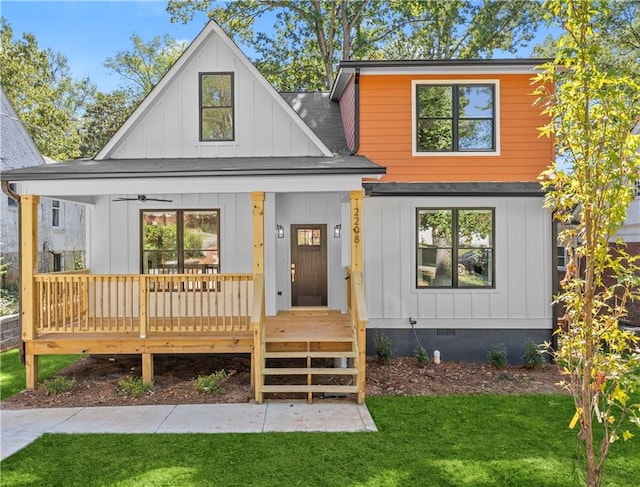 back of house featuring a porch and a yard