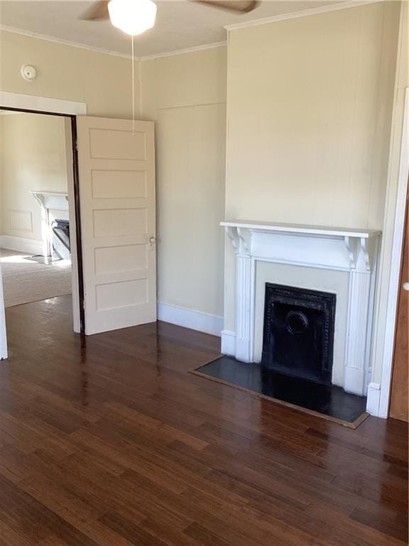 unfurnished living room with ceiling fan, ornamental molding, and dark hardwood / wood-style floors