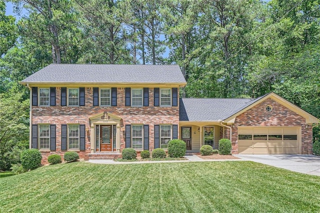 3592 Midvale Cv, Tucker, GA 30084 - view of front of home with concrete driveway, a garage, a front yard, and brick siding