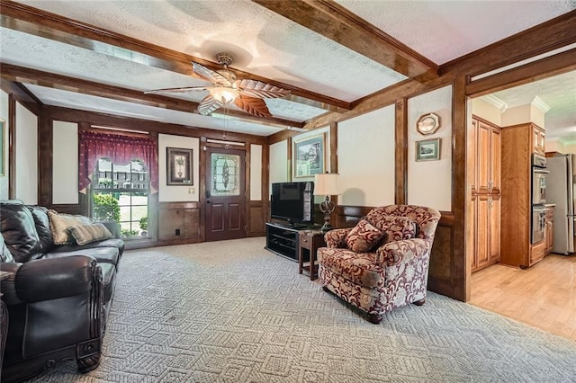 3592 Midvale Cv, Tucker, GA 30084 - living area featuring light carpet, ceiling fan, a textured ceiling, beamed ceiling, and wainscoting