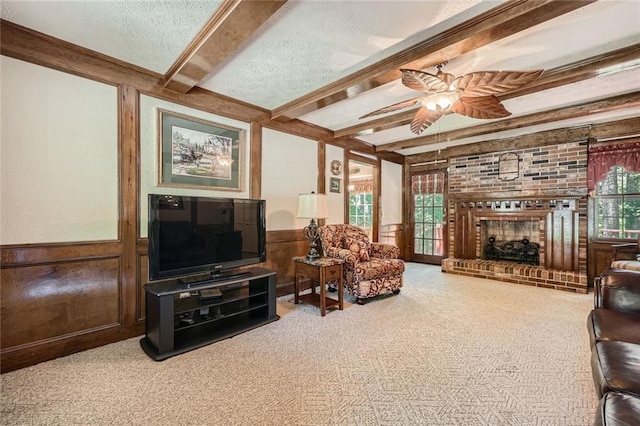 3592 Midvale Cv, Tucker, GA 30084 - living room with a brick fireplace, beam ceiling, carpet floors, a ceiling fan, and wainscoting