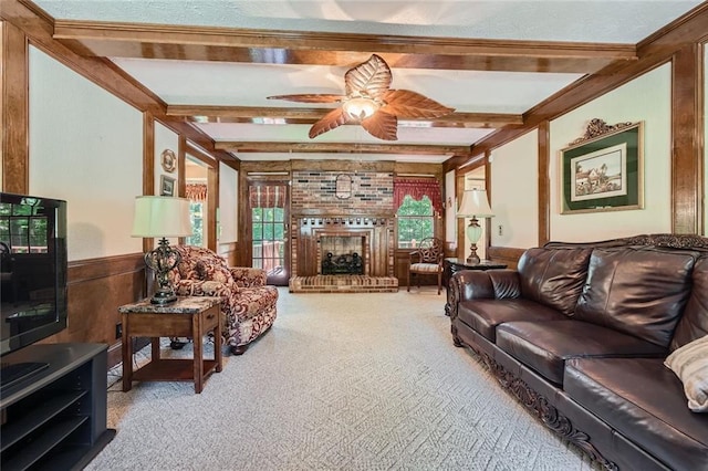 3592 Midvale Cv, Tucker, GA 30084 - carpeted living room with beamed ceiling, a ceiling fan, a wainscoted wall, a fireplace, and wood walls