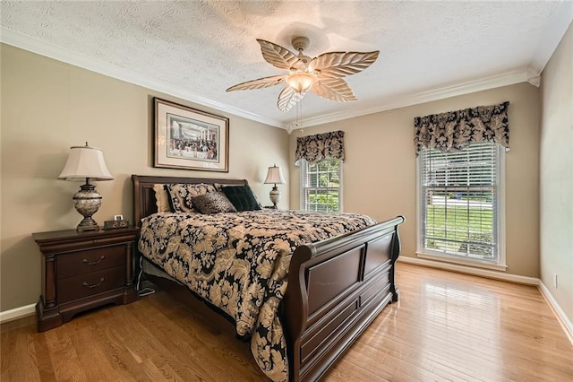 3592 Midvale Cv, Tucker, GA 30084 - bedroom with light wood-style floors, a textured ceiling, ornamental molding, baseboards, and a ceiling fan