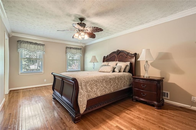 3592 Midvale Cv, Tucker, GA 30084 - bedroom with light wood-style flooring, baseboards, crown molding, a textured ceiling, and ceiling fan