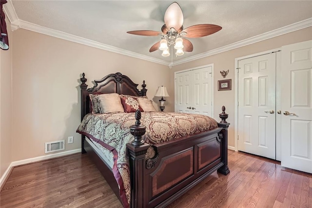 3592 Midvale Cv, Tucker, GA 30084 - bedroom featuring two closets, wood finished floors, ornamental molding, baseboards, and ceiling fan