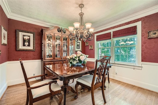 3592 Midvale Cv, Tucker, GA 30084 - dining room featuring a chandelier, light wood-type flooring, a textured ceiling, and crown molding