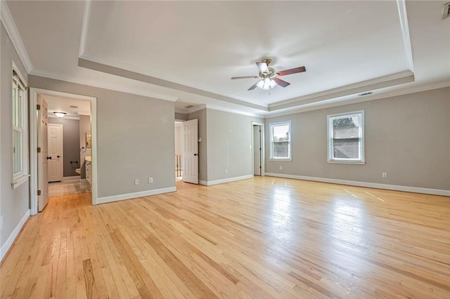 interior space with ceiling fan, light hardwood / wood-style flooring, crown molding, and a raised ceiling