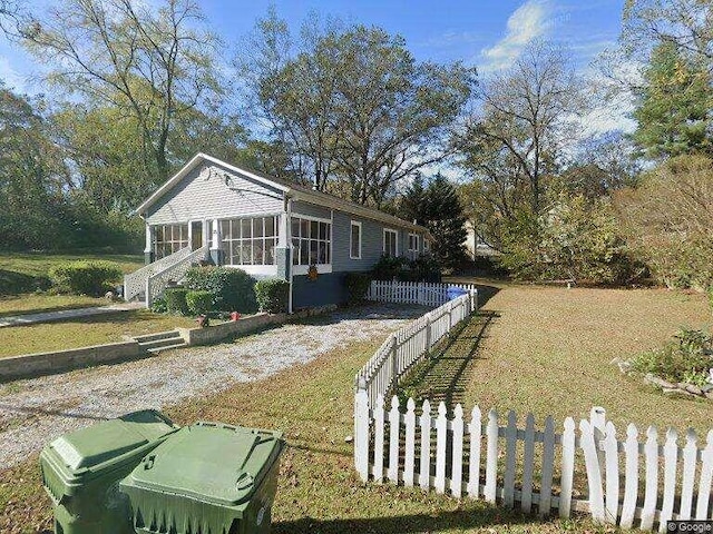 view of property exterior with a sunroom