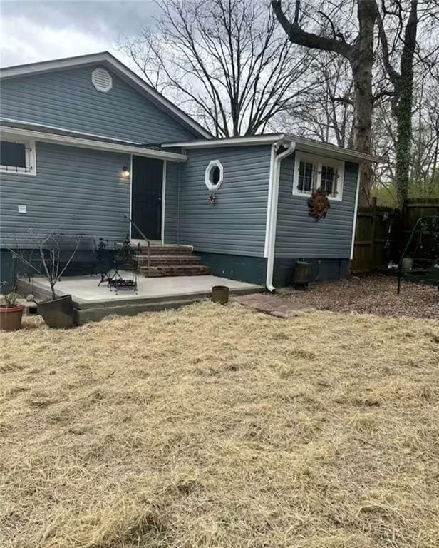 back of house featuring a yard and a patio